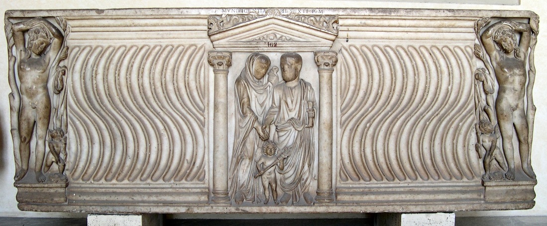 Roman strigillated sarcophagus with portrait of a couple flanked by standing mythological figure. Third century AD. Rome, Vatican Museums (inv. 9253).